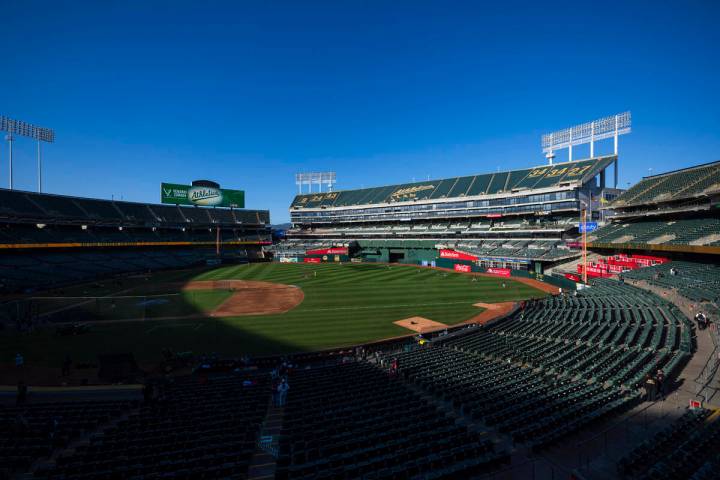 Fans walk to their seats before the start of a baseball game, April 2, 2024, in Oakland, Calif. ...