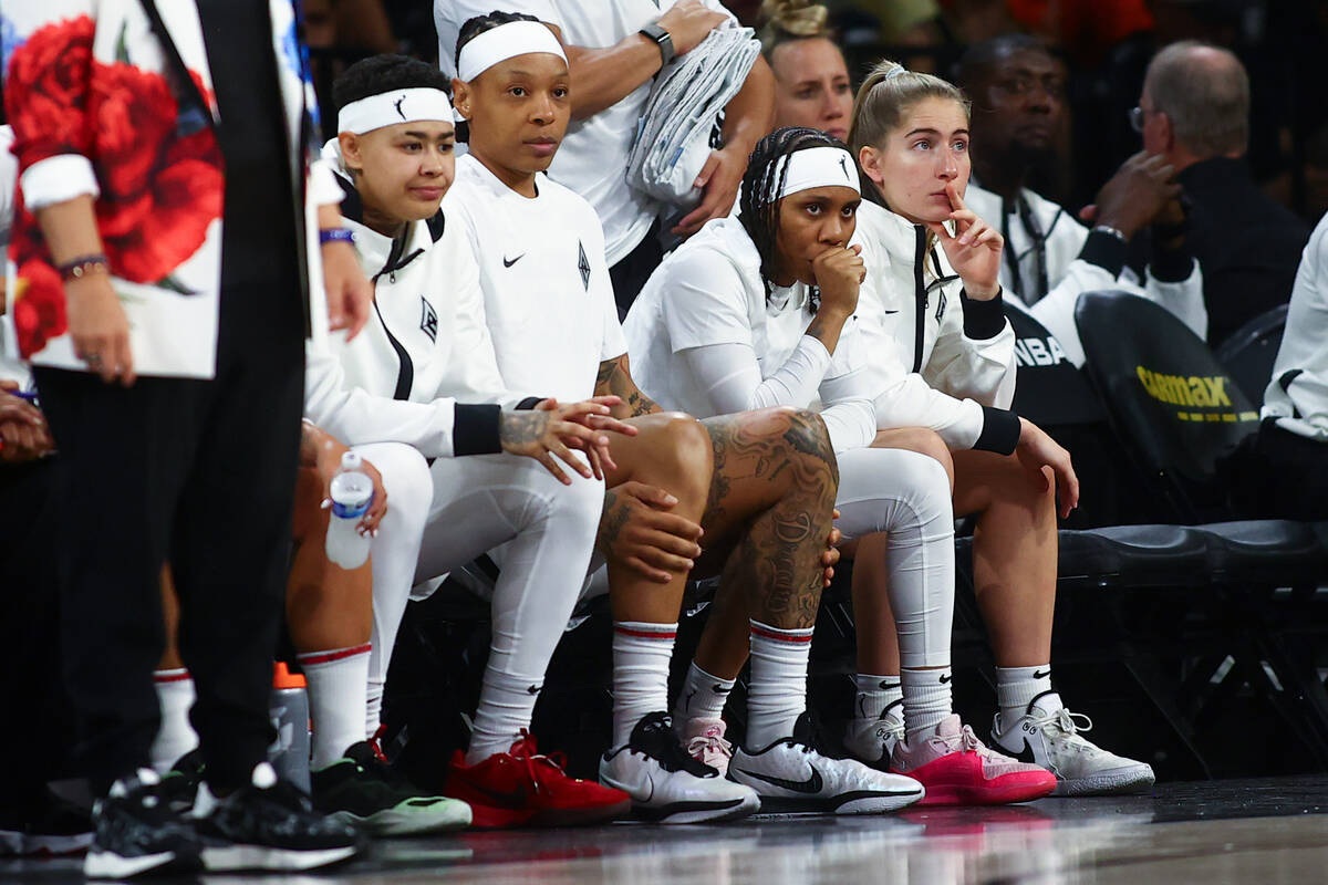 The Las Vegas Aces bench, including Kierstan Bell, left, Emma Cannon, Dyaisha Fair and Kate Mar ...