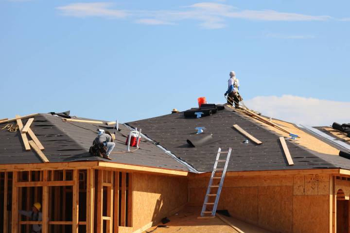 Construction workers labor on rooftops in swelling heat at the Coronado Condominiums in Summerl ...