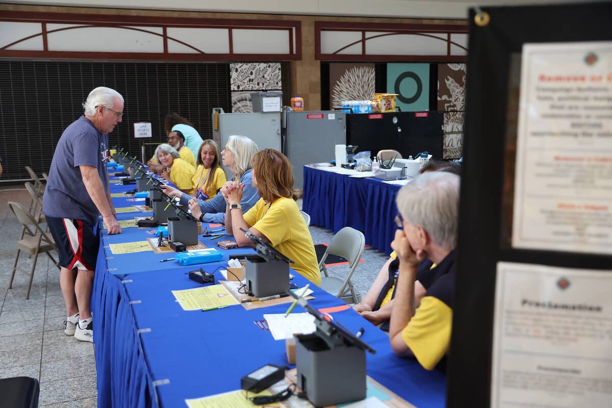 Voters cast their ballots during the early voting period at a polling location at the Galleria ...