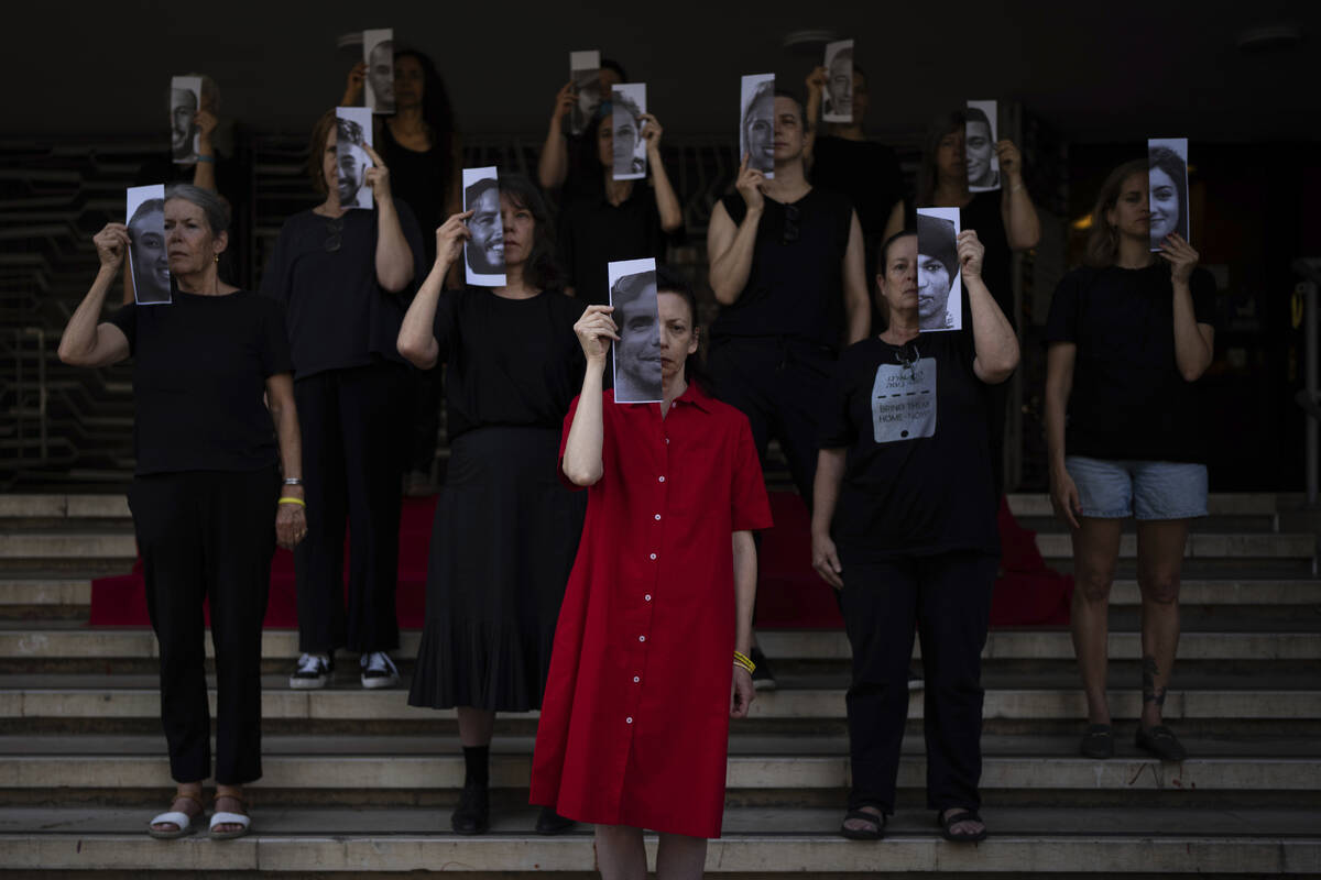 Relatives and supporters of Israeli hostages held by Hamas in Gaza hold photos of their loved o ...