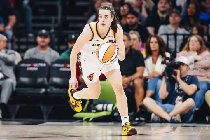 Indiana Fever guard Caitlin Clark (22) dribbles the ball during a game between the Aces and Ind ...