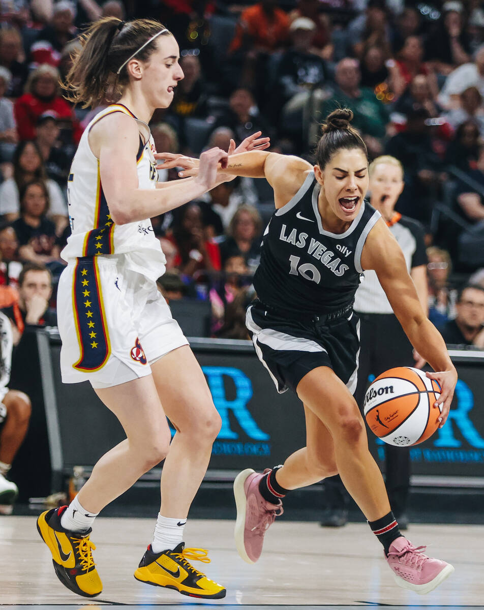 Aces guard Kelsey Plum (10) drives the ball past Indiana Fever guard Caitlin Clark (22) during ...