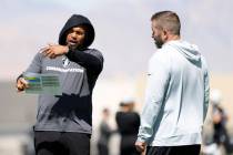 Raiders head coach Antonio Pierce, left, discusses with Scott Turner, team's pass game coordina ...