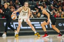 Indiana Fever guard Caitlin Clark (22) dribbles the ball as Aces guard Kelsey Plum (10) guards ...