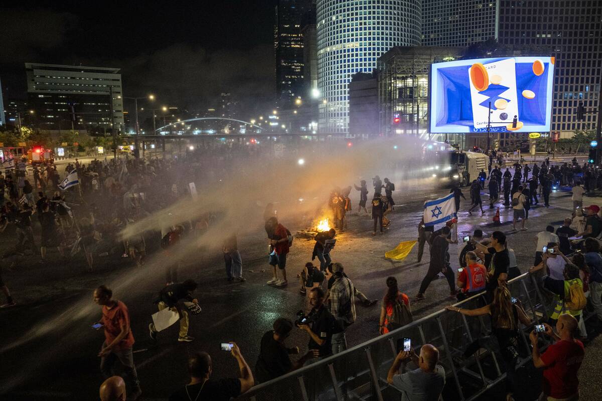 Police use water cannon to disperse demonstrators during a protest against Israeli Prime Minist ...
