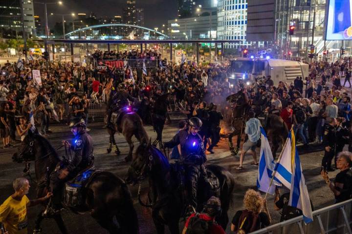 Police use horses to disperse demonstrators during a protest against Israeli Prime Minister Ben ...