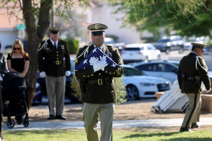 Metropolitan Police Department Honor Guard members present American flags to Brooke and Kylee P ...
