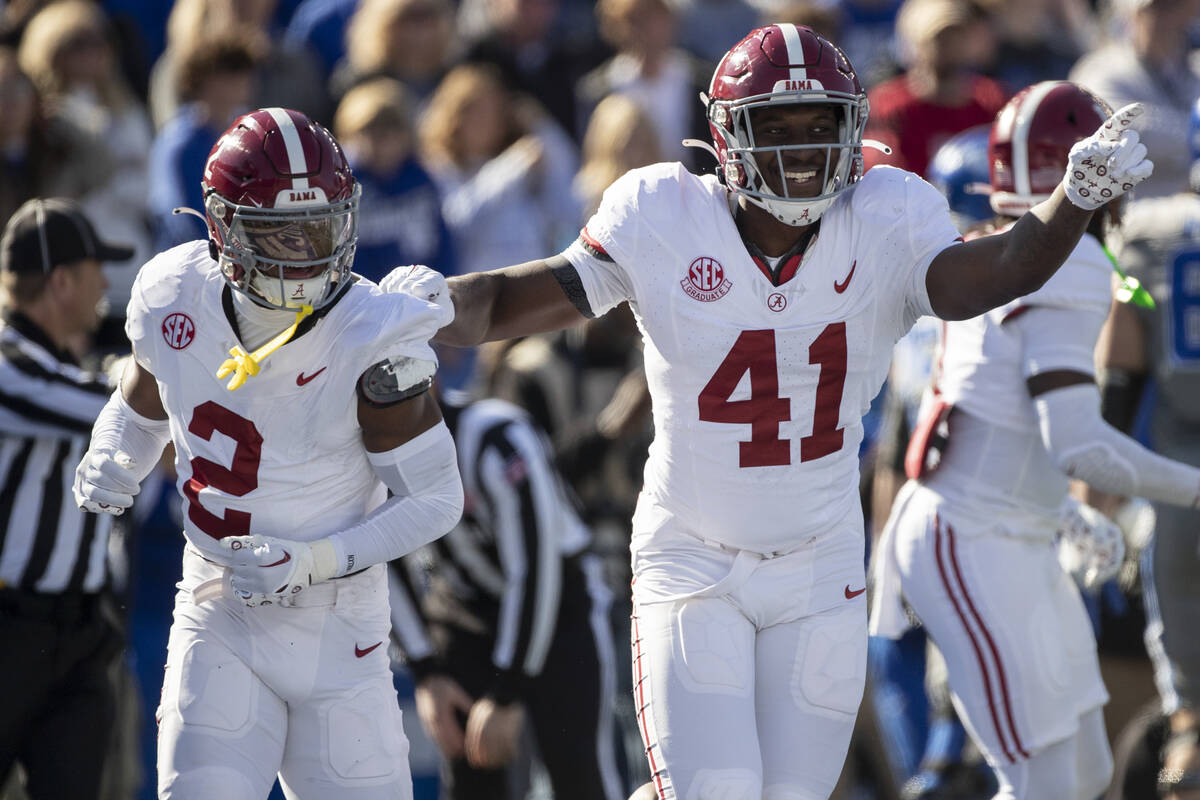 Alabama defensive back Caleb Downs (2) and linebacker Chris Braswell (41) celebrate a fumble re ...