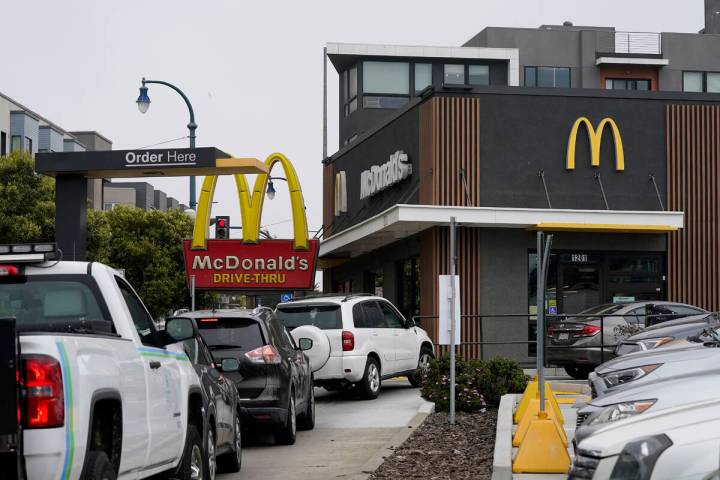 Cars wait in the drive-thru line at a McDonald's restaurant in San Francisco, Thursday, Aug. 25 ...
