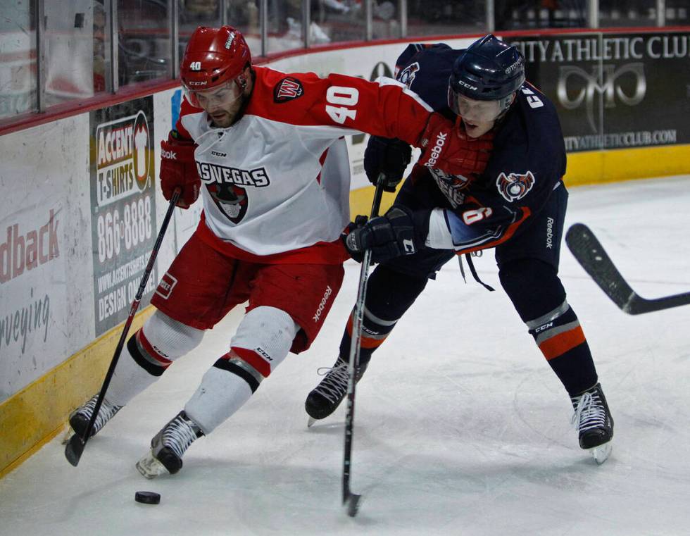 Carlo Finucci, left, of the Wranglers skates by Matt Clune of the Ontario Reign at the Orleans ...