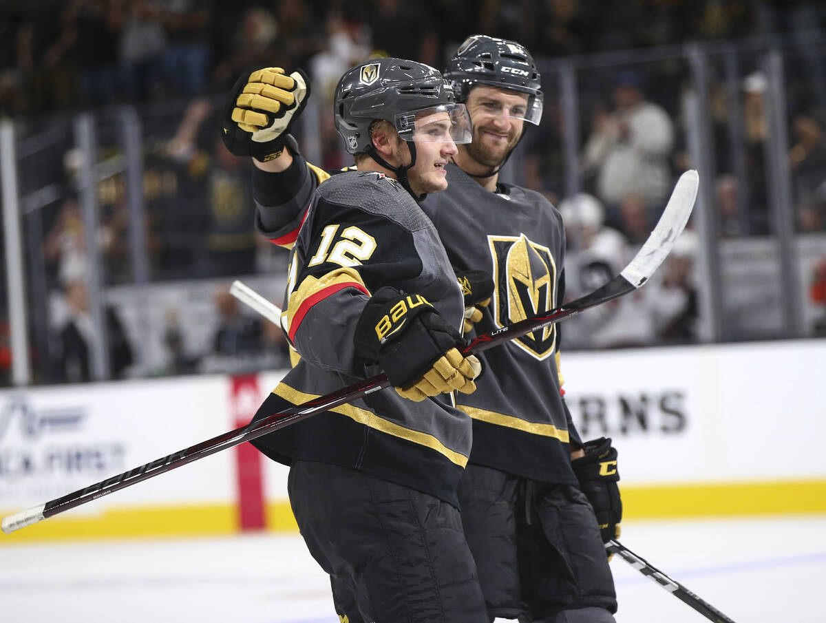Golden Knights defenseman Erik Brannstrom (12) celebrates his goal with defenseman Colin Miller ...