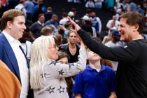 Dallas Mavericks Governor Patrick Dumont (left), watches Miriam Adelson, (center) controlling ...