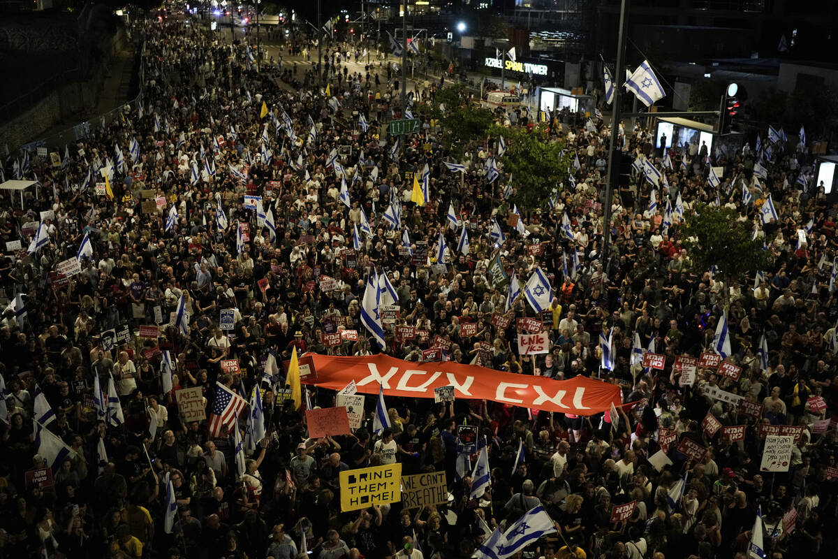 FILE - People protest against Israeli Prime Minister Benjamin Netanyahu's government and call f ...