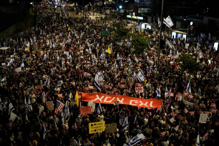 FILE - People protest against Israeli Prime Minister Benjamin Netanyahu's government and call f ...