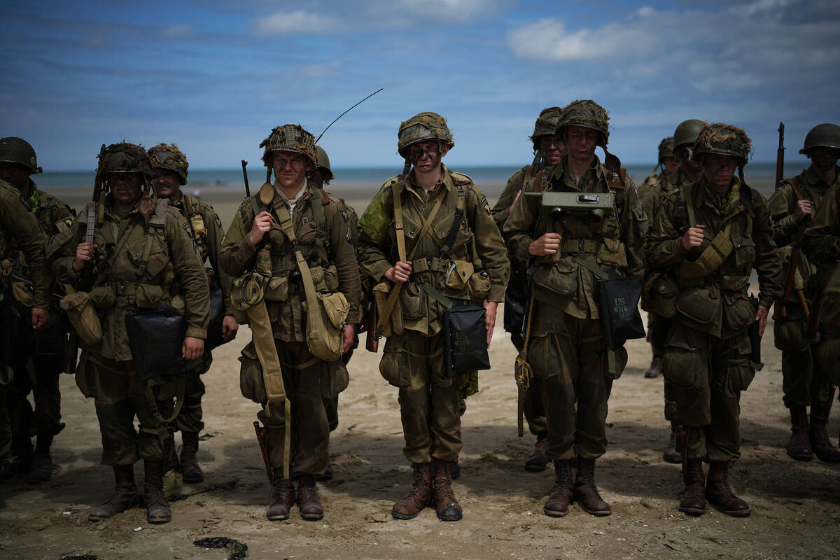 Reenactors take part in a ceremony along Utah Beach near Sainte-Marie-du-Mont, Normandy, France ...