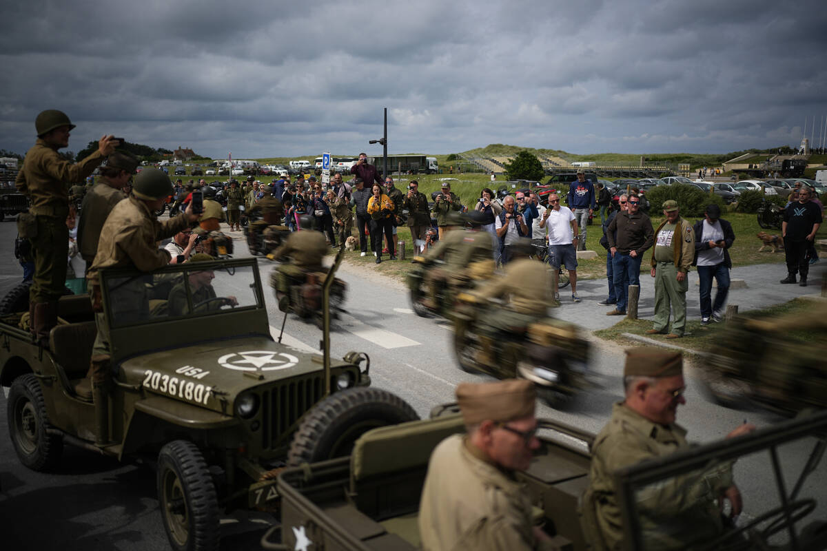 US army vintage Harley Davidson motorbikes speed by Utah Beach near Sainte-Marie-du-Mont, Norma ...