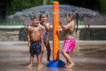Children play in the splash pad at Monte Vista Park in Chino, Calif. on Tuesday, Aug. 30, 2022. ...