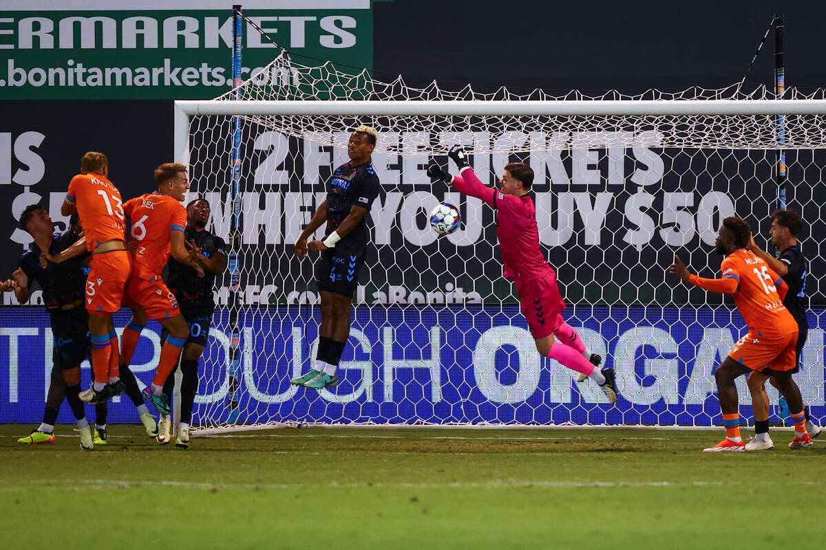 Las Vegas Lights FC goaltender Nicholas Ammeter and defender Fabien Garcia (4) thwart an attemp ...