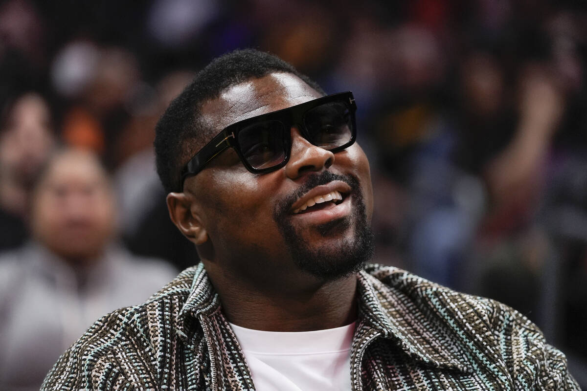 Los Angeles Chargers linebacker Khalil Mack watches during the second half of a WNBA basketball ...