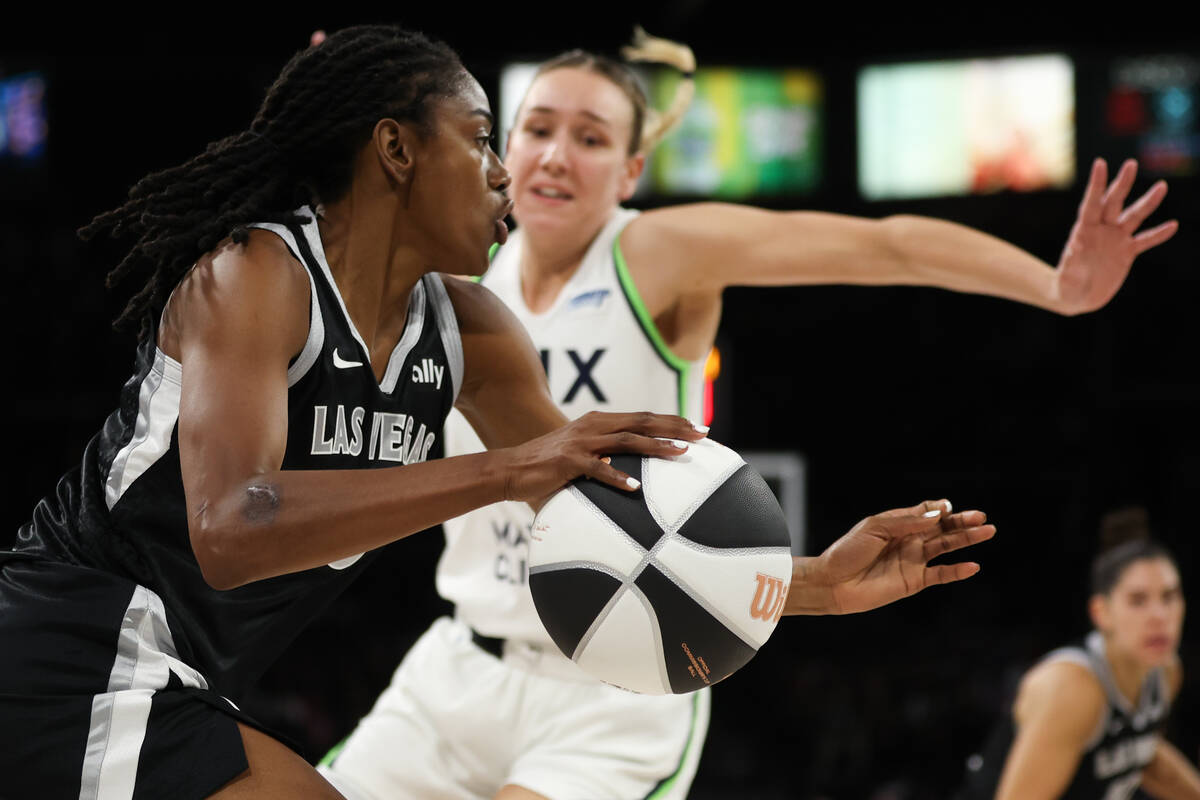 Las Vegas Aces guard Tiffany Hayes, left, drives toward the hoop against Minnesota Lynx forward ...
