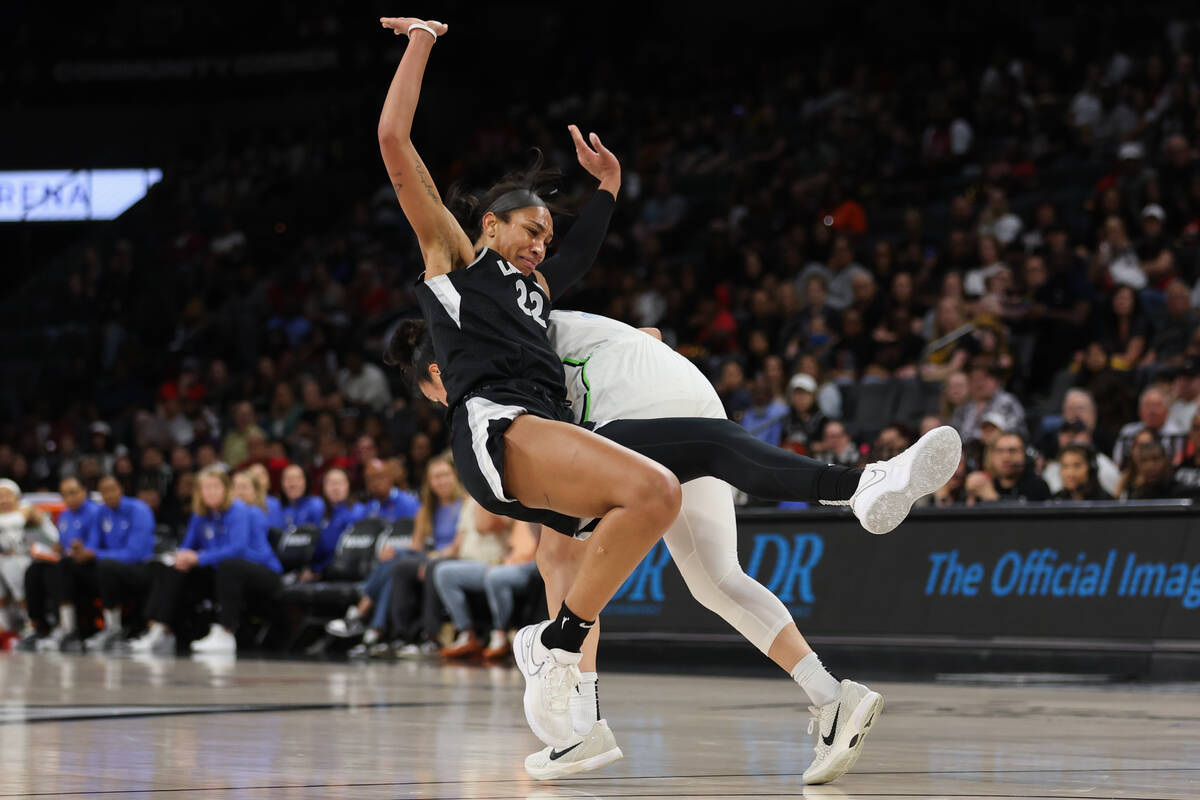 Las Vegas Aces center A'ja Wilson (22) tangles with Minnesota Lynx guard Kayla McBride during t ...
