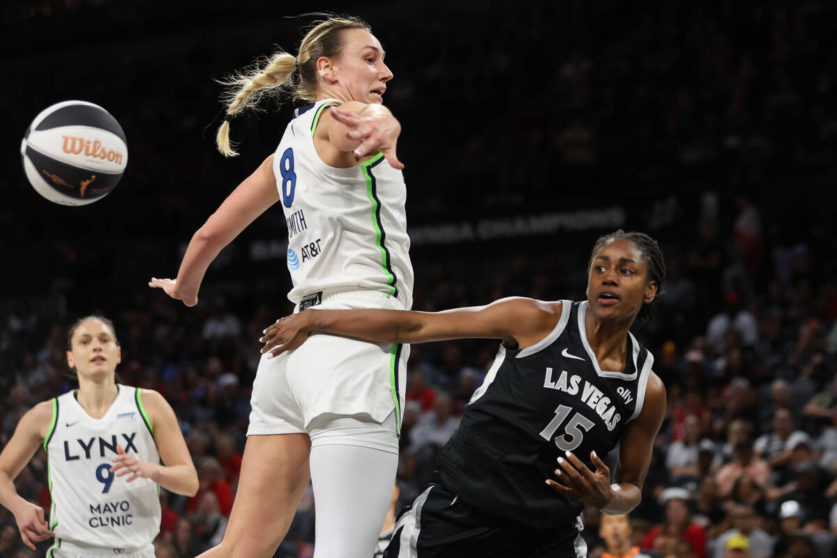 Las Vegas Aces guard Tiffany Hayes (15) passes around Minnesota Lynx forward Alanna Smith (8) w ...