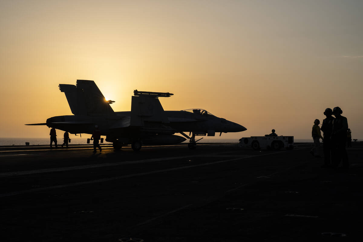 A fighter jet parks on the deck of the USS aircraft carrier Dwight D. Eisenhower, also known as ...