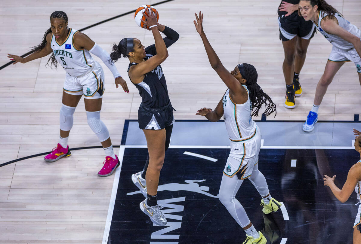 Aces center A'ja Wilson (22) elevates to shoot over New York Liberty forward Jonquel Jones (35) ...