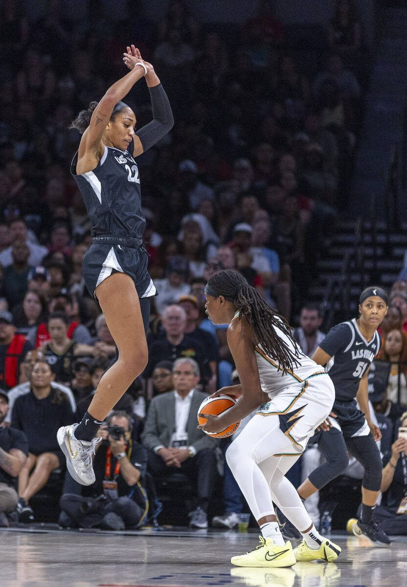 Aces center A'ja Wilson (22) jumps up expecting a shot by New York Liberty forward Jonquel Jone ...