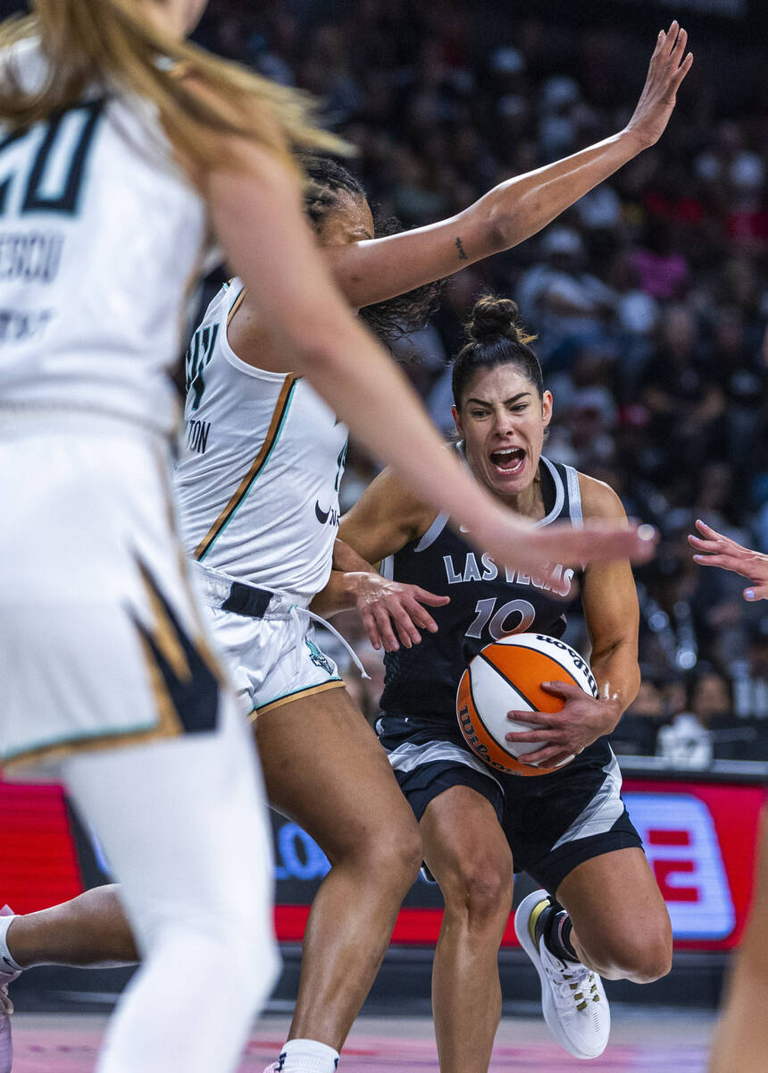 Aces guard Kelsey Plum (10) battles in the lane against New York Liberty forward Betnijah Laney ...