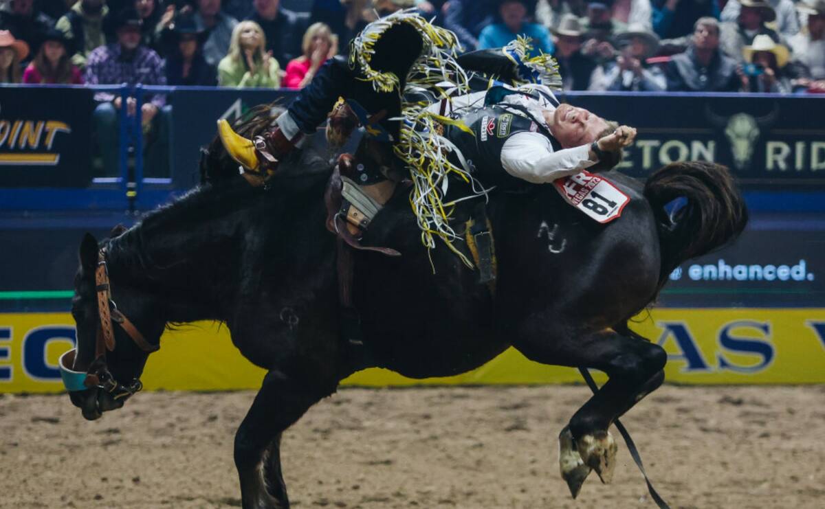 Jacob Lees rides Scarlett Belle during round one of bareback riding at NFR in the Thomas & Mack ...