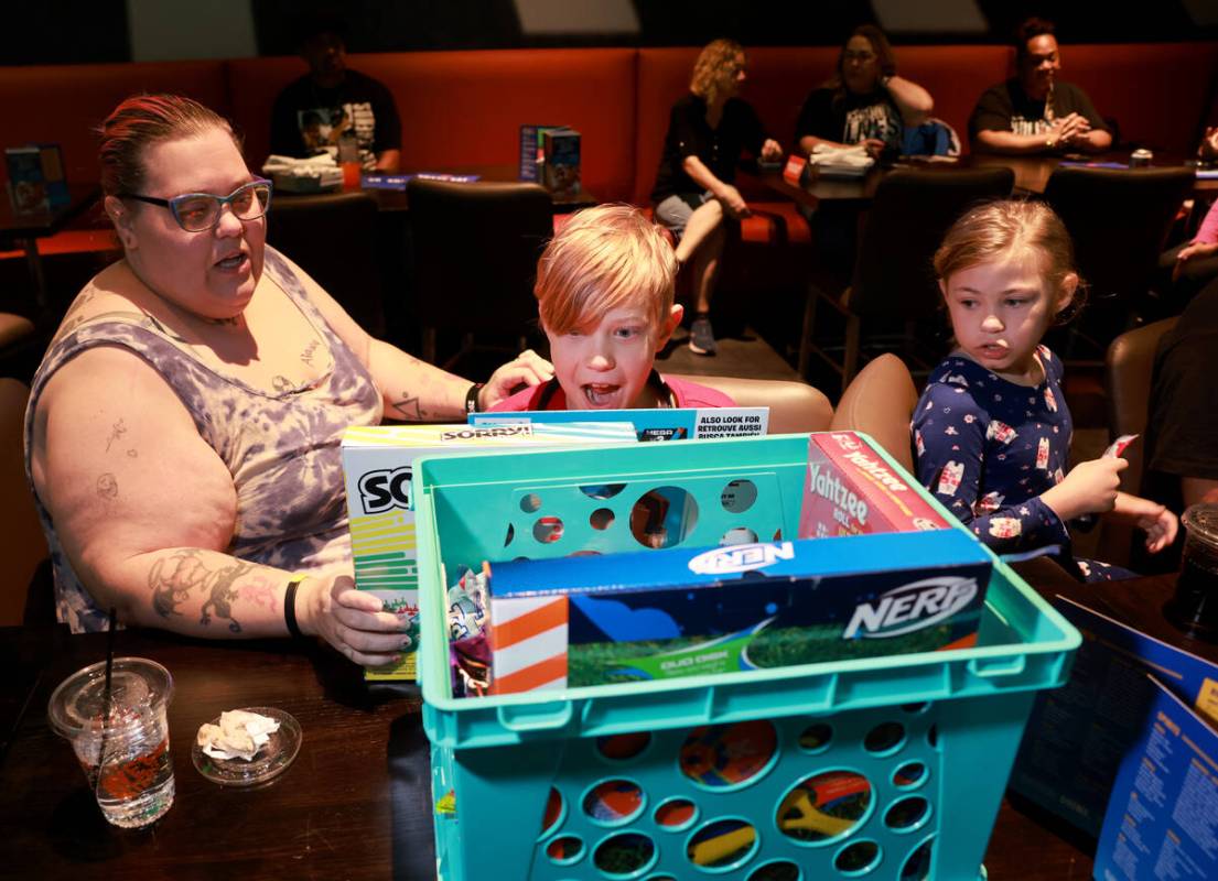 The recently reunified Melius family, from left, mom Elizabeth, Viktor, 11, and Zoey, 8, check ...