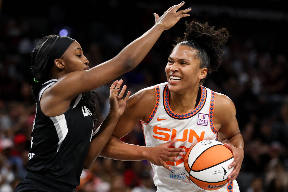 Connecticut Sun forward Alyssa Thomas, right, drives toward the hoop against Las Vegas Aces gua ...