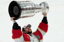 Florida Panthers goaltender Sergei Bobrovsky hoists the NHL hockey Stanley Cup after defeating ...