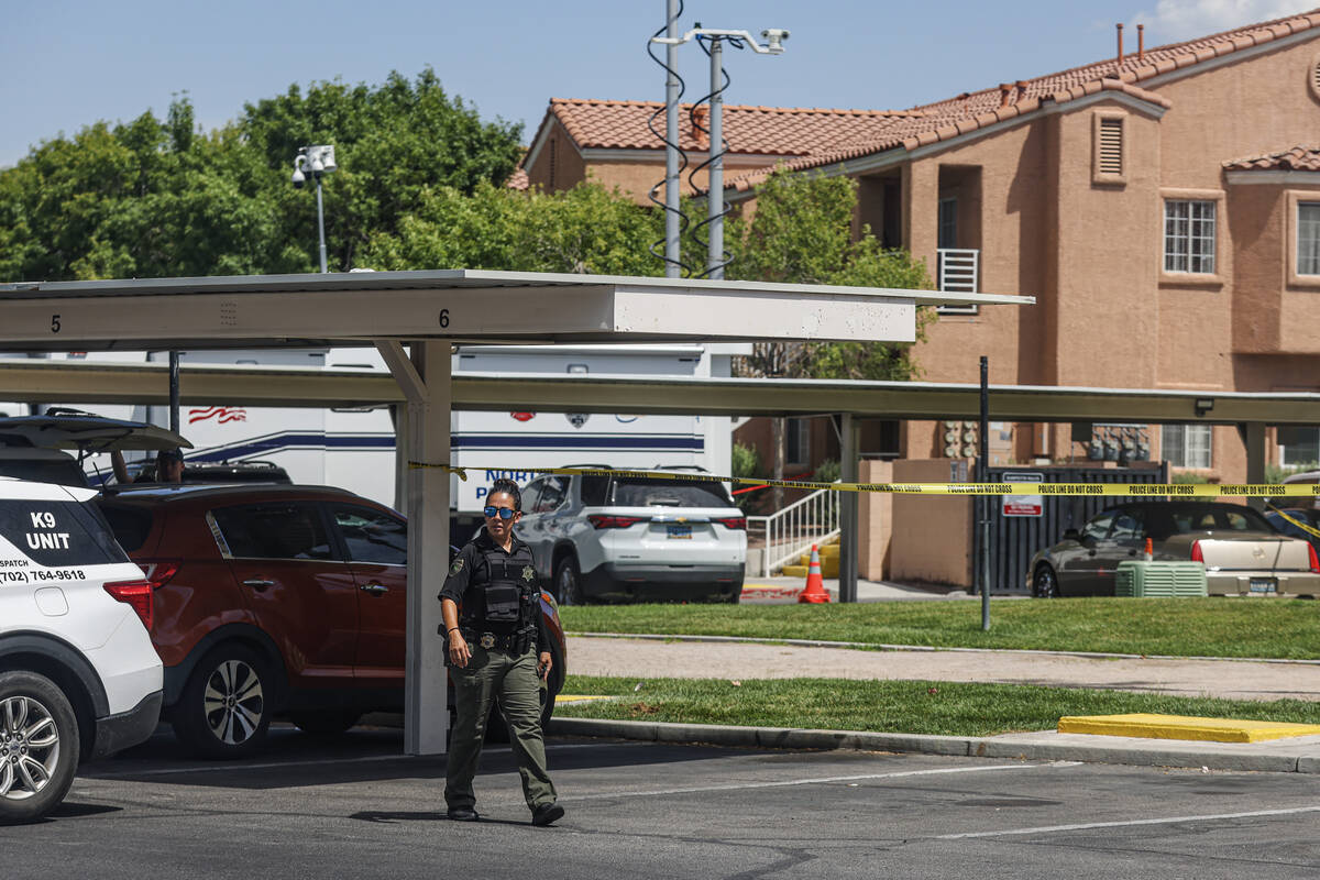 North Las Vegas police investigate the scene where five people were found dead in an apartment ...