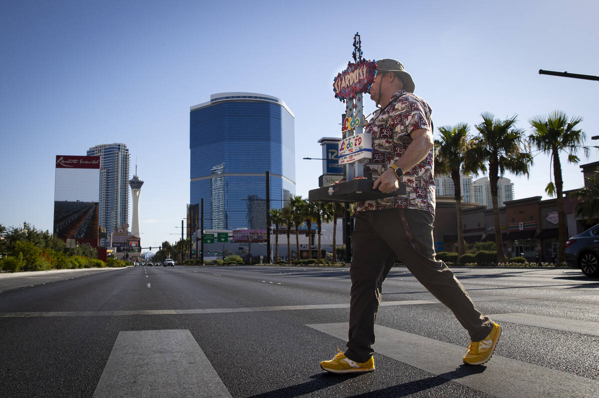 Chris Raley, of Route 9 Signs, based out of Fresno, Calif, carries his miniature replica of the ...