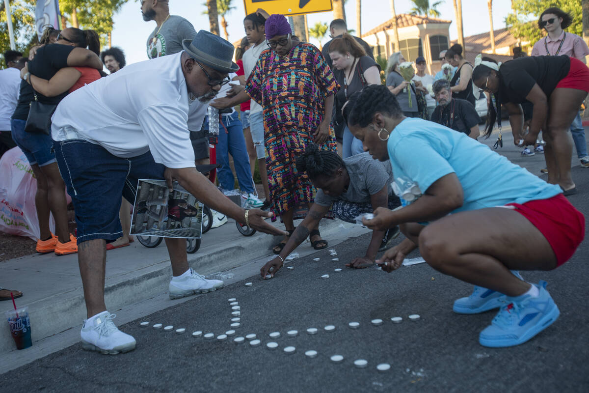 Candles are placed near the sidewalk before a vigil for Kayla Harris at Craig Ranch Villas, Wed ...