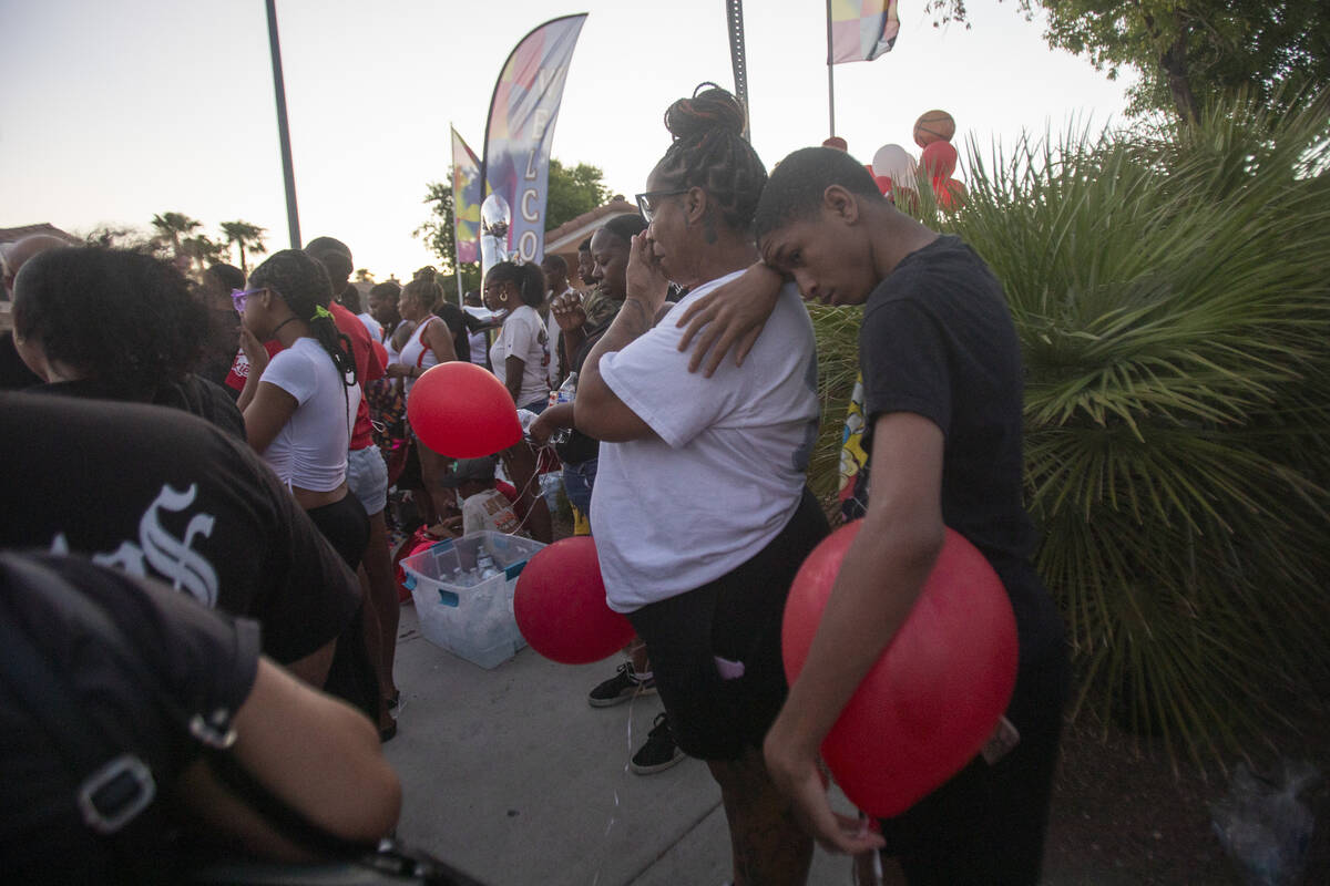 Mourners gather during a candlelight service for Kayla Harris at Craig Ranch Villas, Wednesday, ...