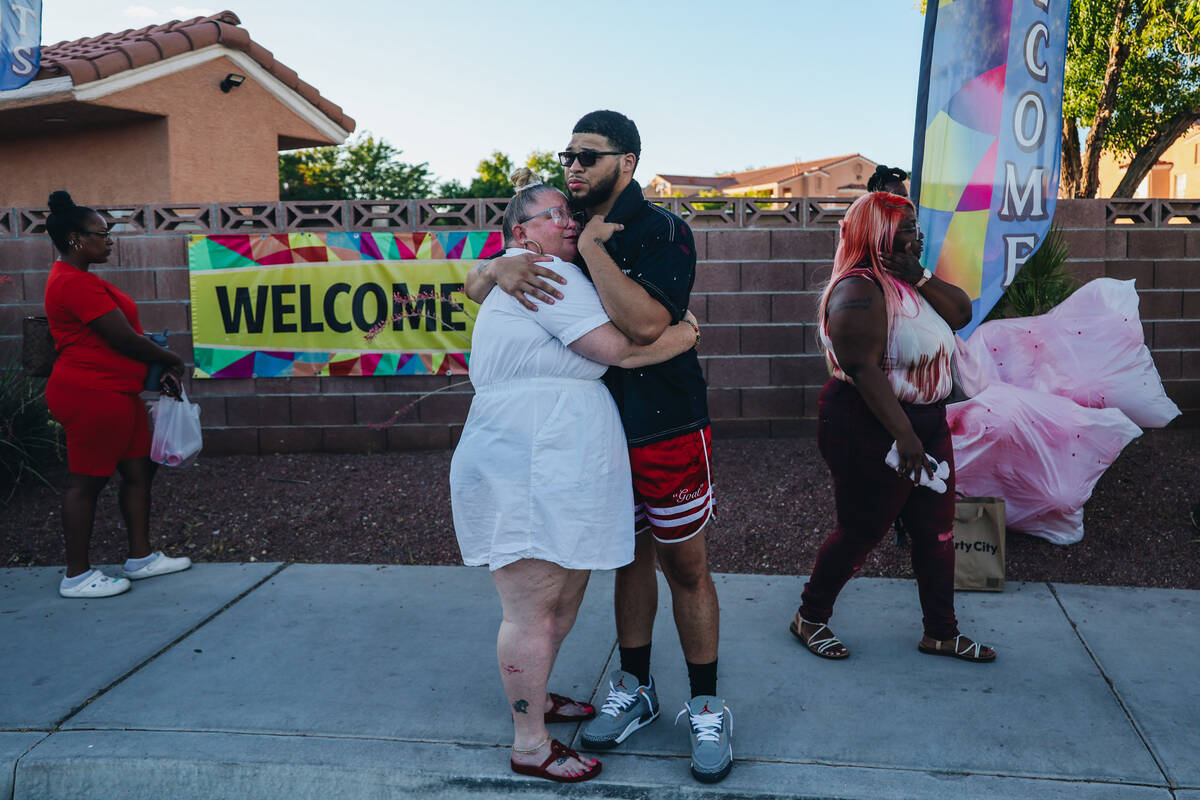 Jalen Simmons, Kayla Harris’ older brother, hugs a mourner during a vigil for Kayla Harris, w ...