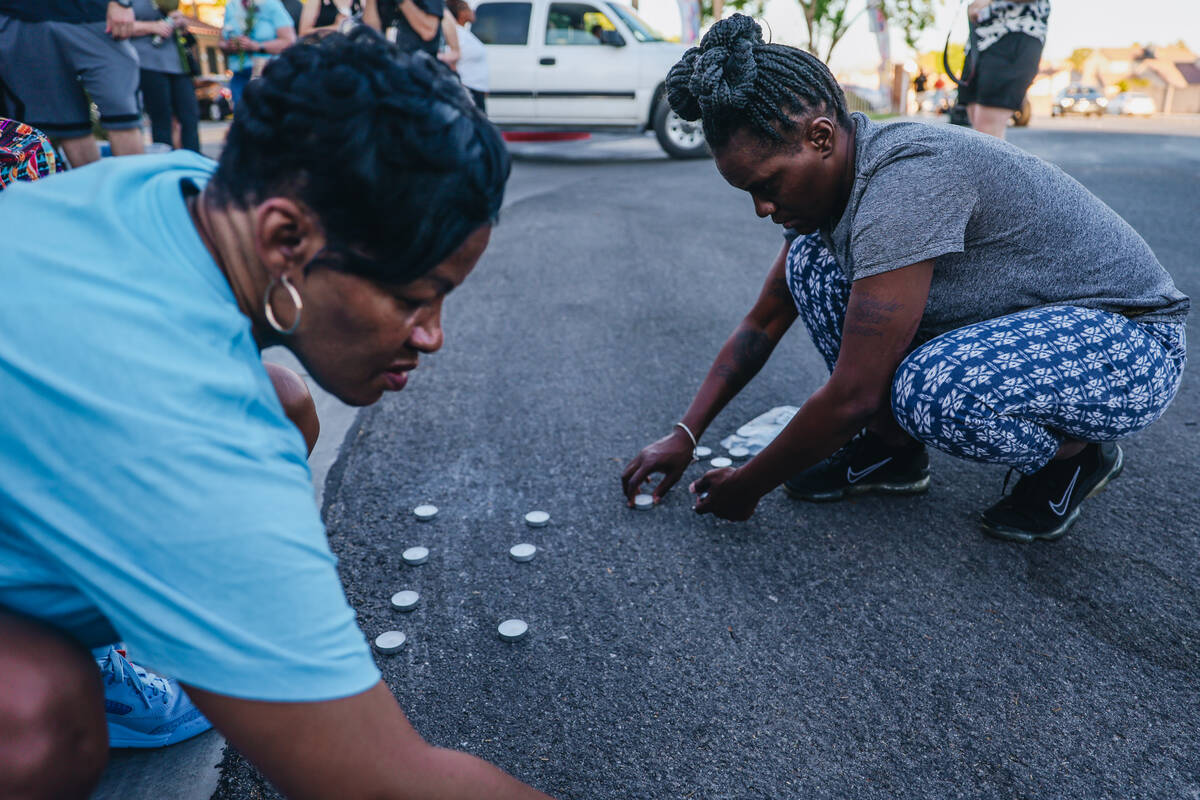 Mourners light candles during a vigil for Kayla Harris, who was killed in a quintuple homicide ...