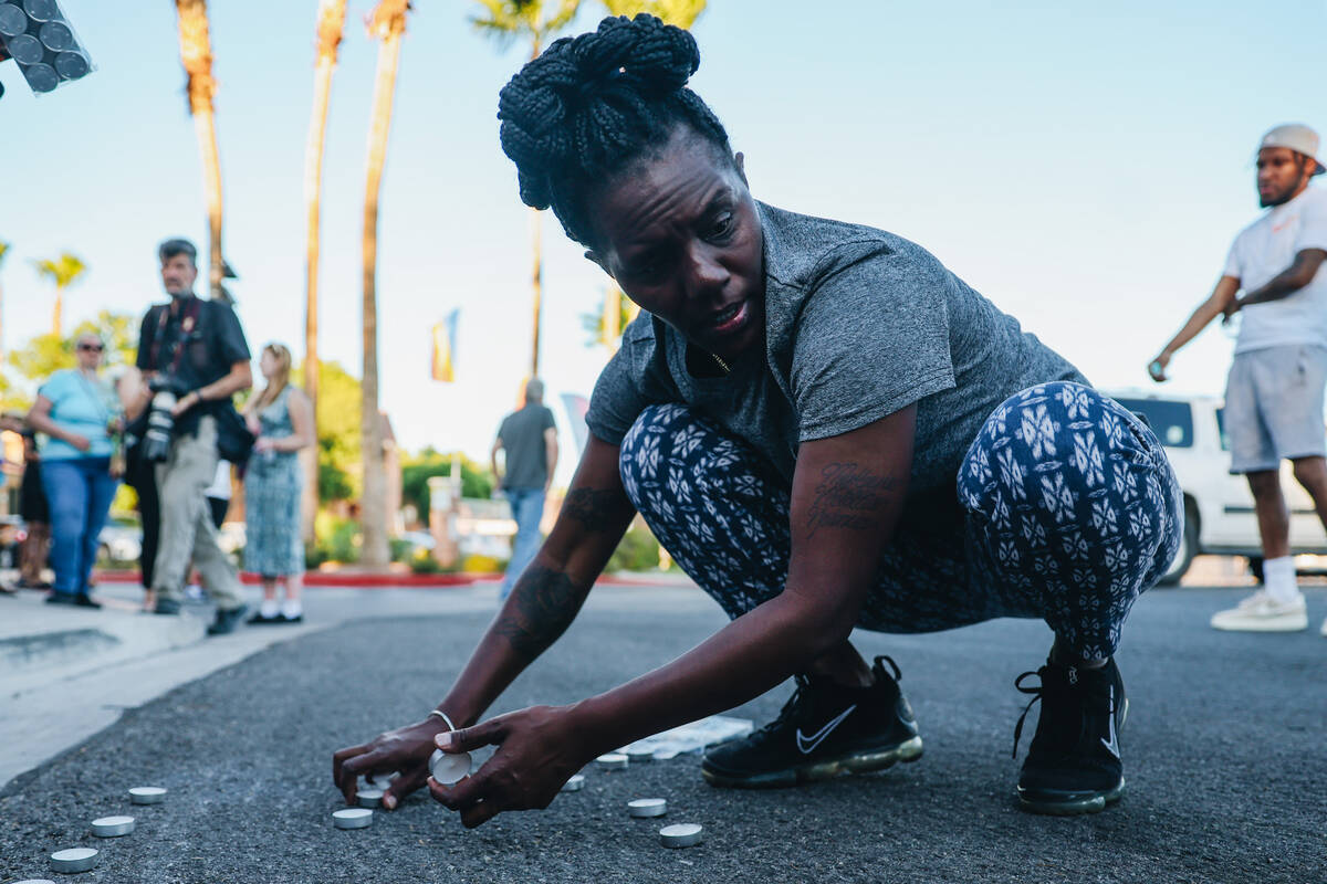 Mourners light candles during a vigil for Kayla Harris, who was killed in a quintuple homicide ...