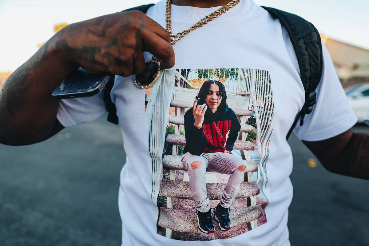 A mourner shows off a shirt with Kayla Harris on it during a vigil for Kayla Harris, who was ki ...