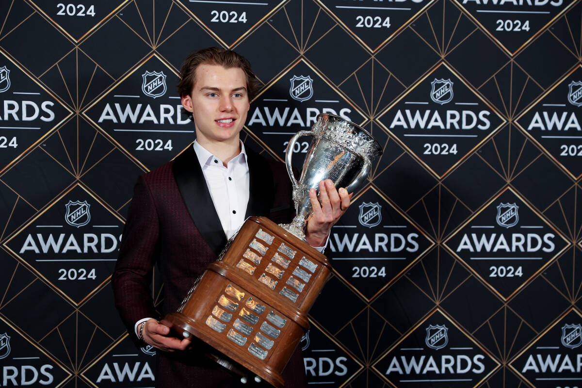 Chicago Blackhawks center Connor Bedard holds the Calder Memorial Trophy after winning the hono ...