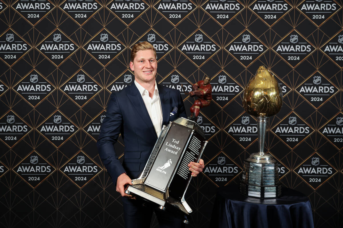 Colorado Avalanche center Nathan MacKinnon poses with the Ted Lindsay Award and the Hart Memori ...