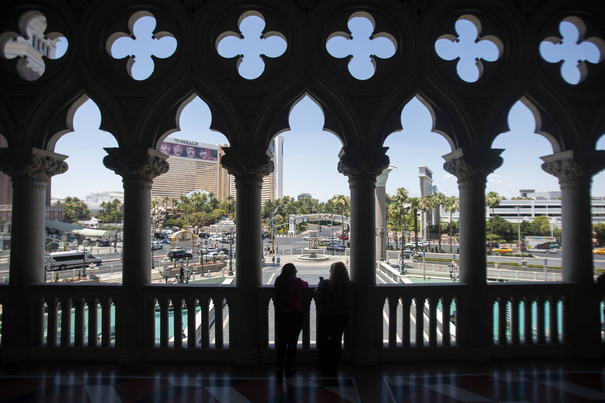 A group of tourists look out onto the Strip from The Venetian, Thursday, June 27, 2024, in Las ...
