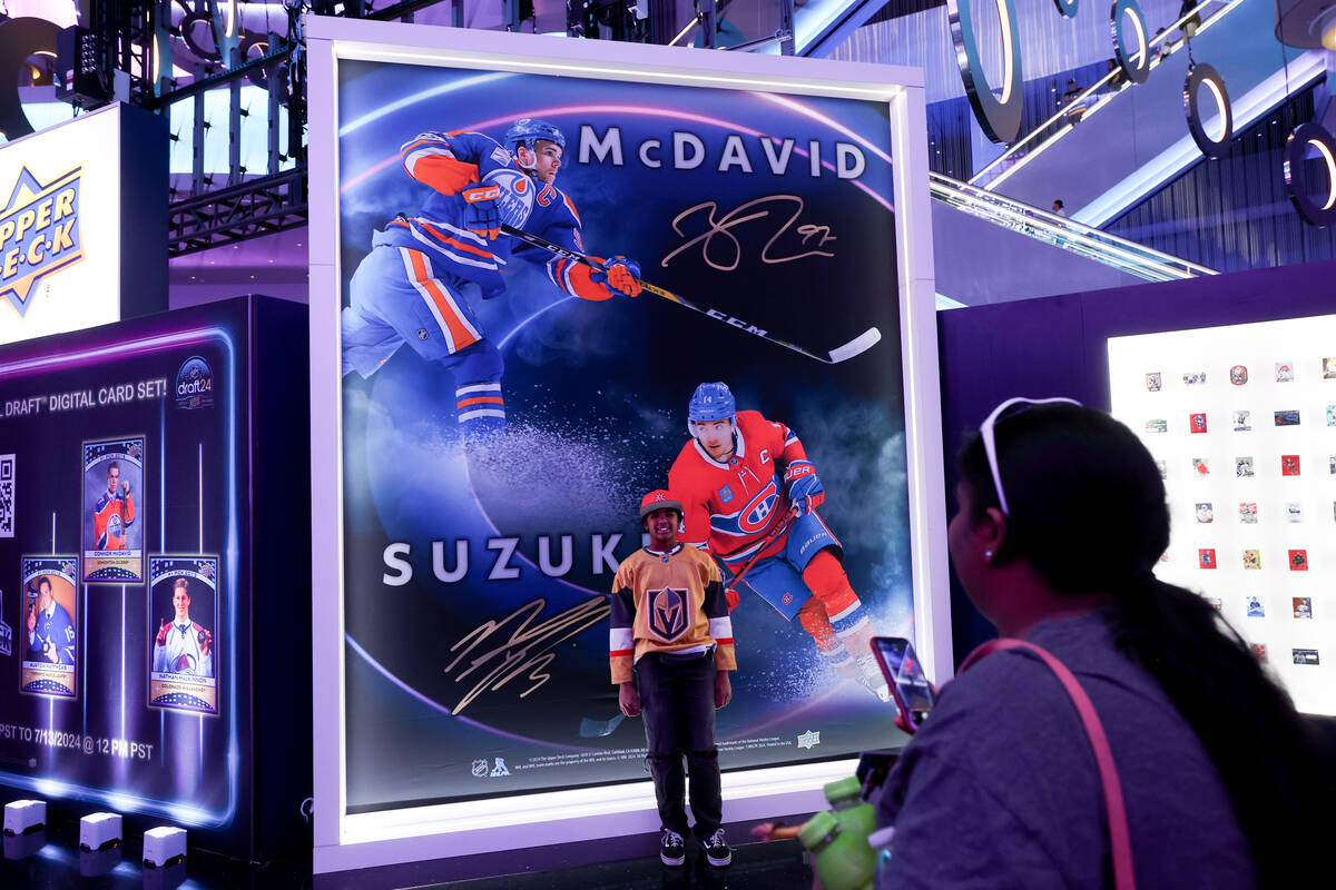 Rachel, 10, of Las Vegas poses while her mother Anusha takes her photo during the NHL hockey dr ...