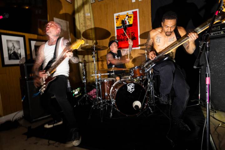 Tim Stewart, left, and Jonny Goood, of Damnage, right, perform with Branden Steineckert, of Ran ...