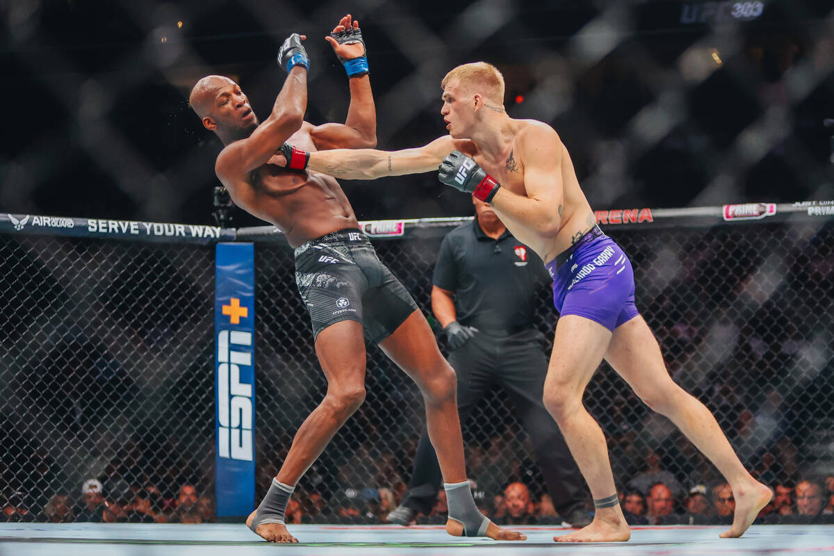 Ian Machado Garry, right, punches Michael Page during their welterweight bout at UFC 303 at T-M ...