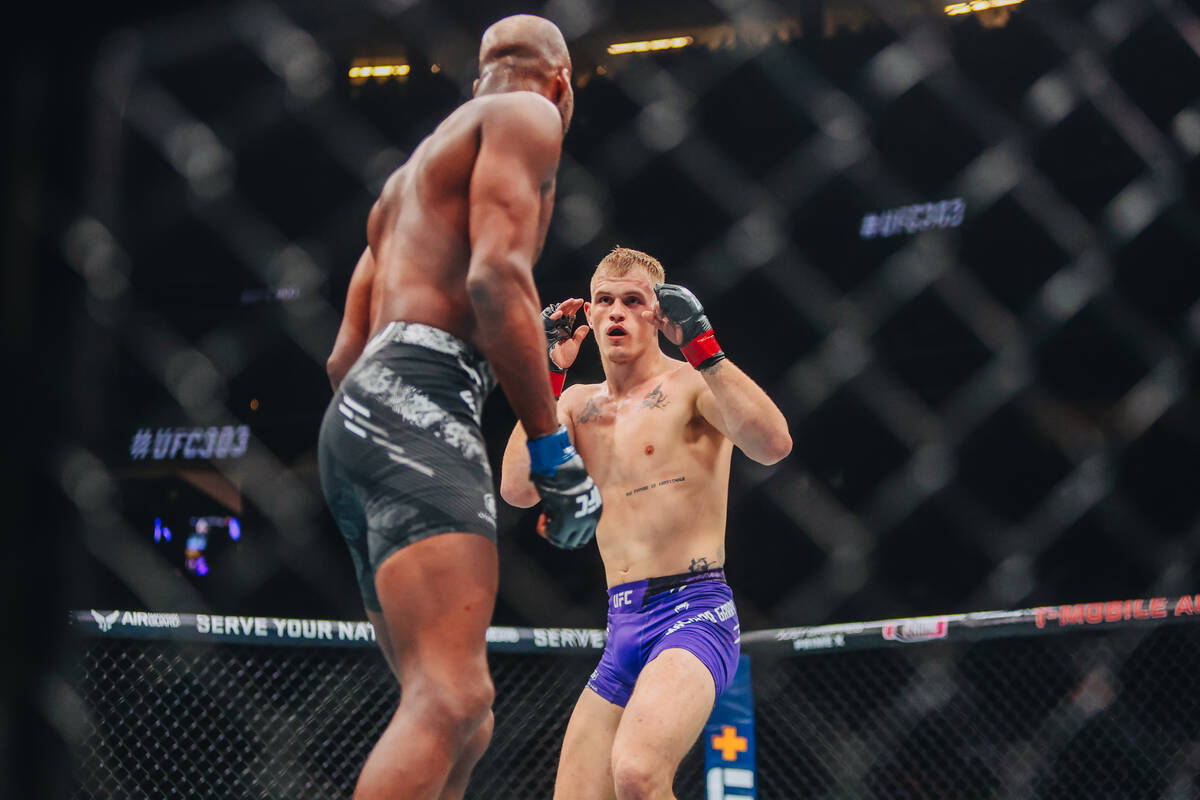 Ian Machado Garry, facing, fights Michael Page during their welterweight bout at UFC 303 at T-M ...